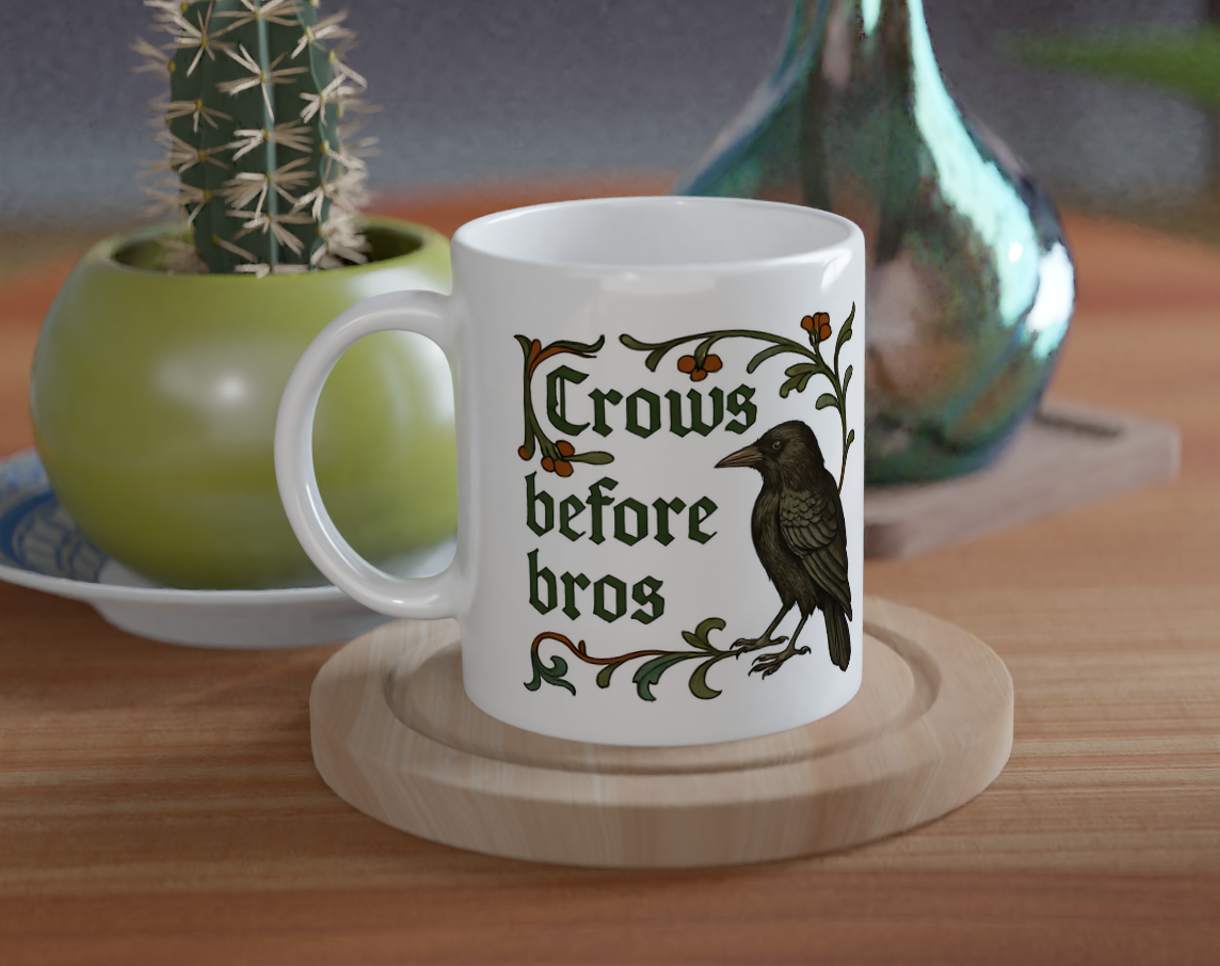 Mug with 'Crows before bros' text on a wooden table with decorative items.