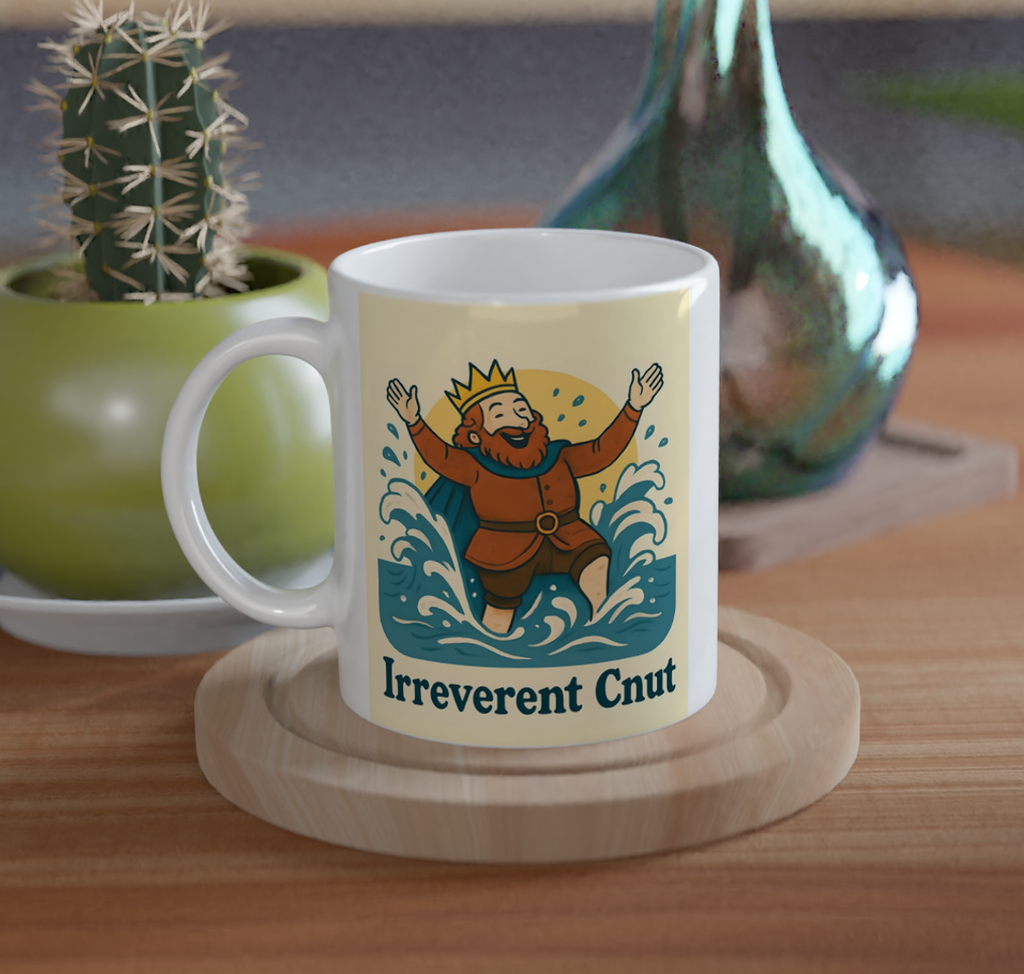 Mug with 'Irreverent Crew' design on a wooden table with plants and a vase.